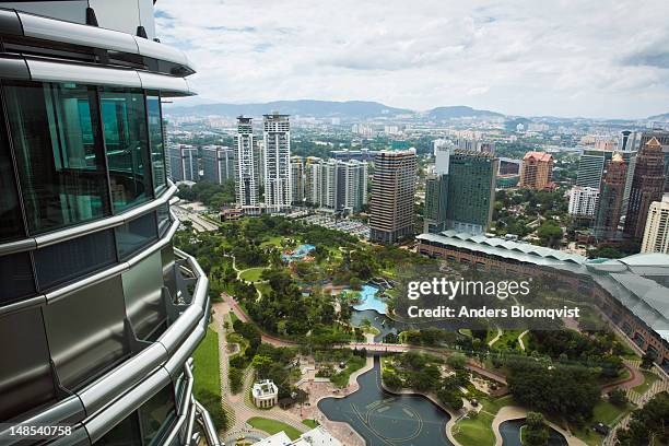 looking down at klcc park from petronas towers skybridge. - skybridge petronas twin towers stock pictures, royalty-free photos & images