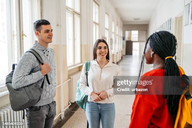 students talking in the hall in university - college campus stockfoto's en -beelden