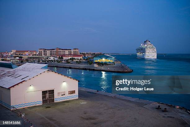 cruise ship departing harbour at dusk. - princess cruises stock pictures, royalty-free photos & images