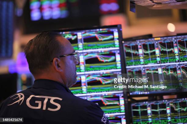 Traders work on the floor of the New York Stock Exchange on April 26, 2023 in New York City. The stock market opened up slightly high as investors...