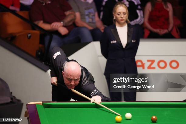 John Higgins of Scotland plays a shot during their Quarter Final match against Mark Selby of England on Day Twelve of the Cazoo World Snooker...