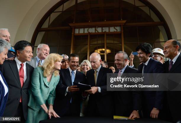 California Gov. Jerry Brown signs a legislation authorizing initial construction of California's $68 billion high-speed rail line with Los Angeles...