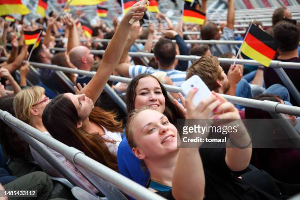 spectators on a stadium - selfie with german flags - national flag stock pictures, royalty-free photos & images