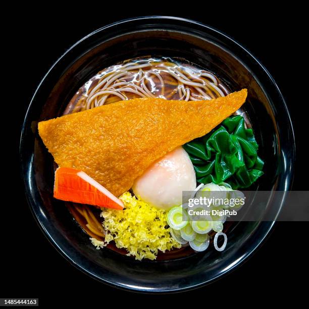 buckwheat soba noodles on black background, food model - aburaage stockfoto's en -beelden