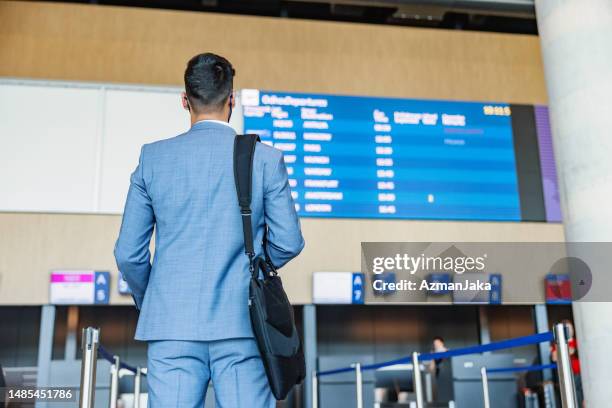 passenger looking at the timetable board - aerial transport building stock pictures, royalty-free photos & images