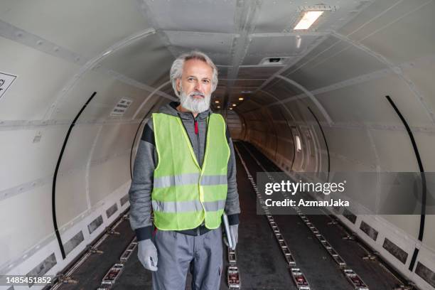 an avionics technician making sure the aircraft functioning properly - airplane tunnel stock pictures, royalty-free photos & images