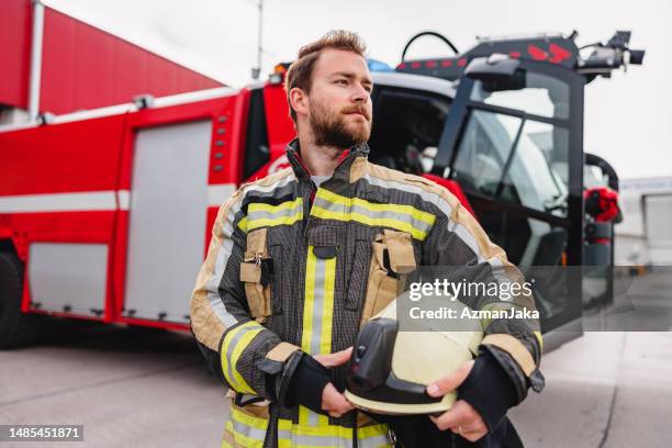 confident fireman at the fire station - firefighter getting dressed stock pictures, royalty-free photos & images