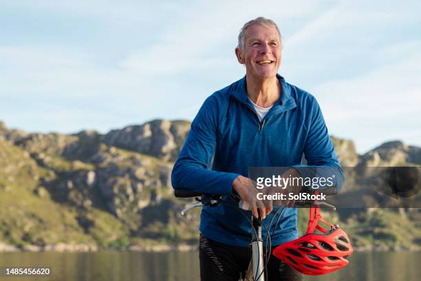 astride his bike looking at the view - season 70 stock pictures, royalty-free photos & images