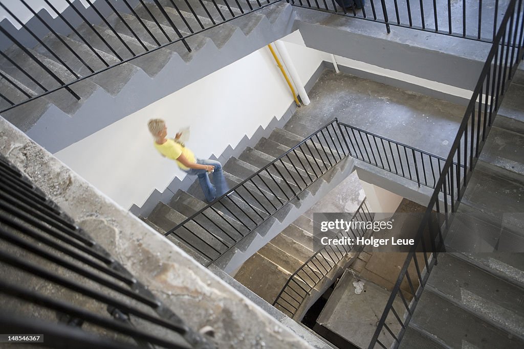 Woman walking down stairway at Eurofilm Studio.