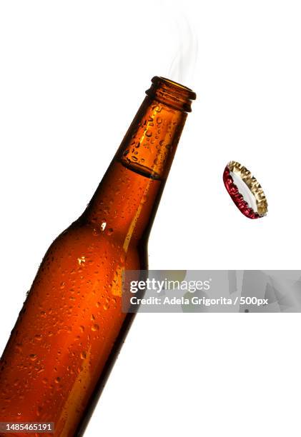 close-up of alcohol bottle against white background,romania - bierfles stockfoto's en -beelden