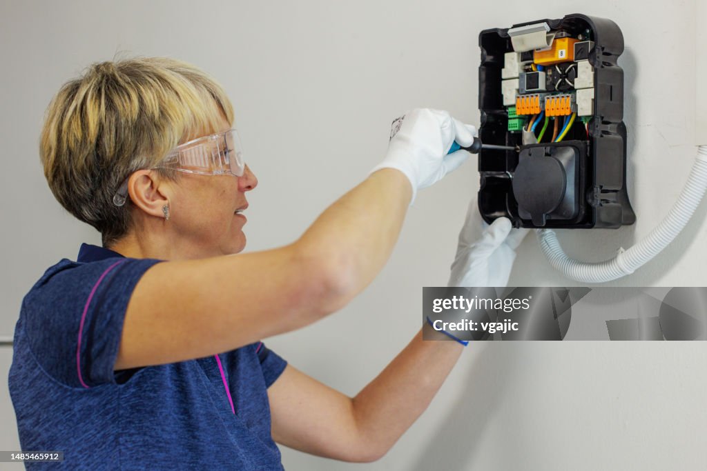 Certified Female Electrician Installing Home EV Charger