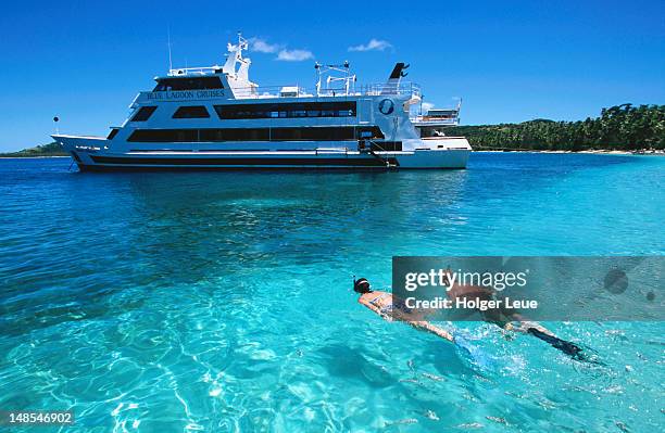 couple snorkelling near the mv nanuya princess, blue lagoon cruise, nanuya lailai island. - princess cruises stock pictures, royalty-free photos & images