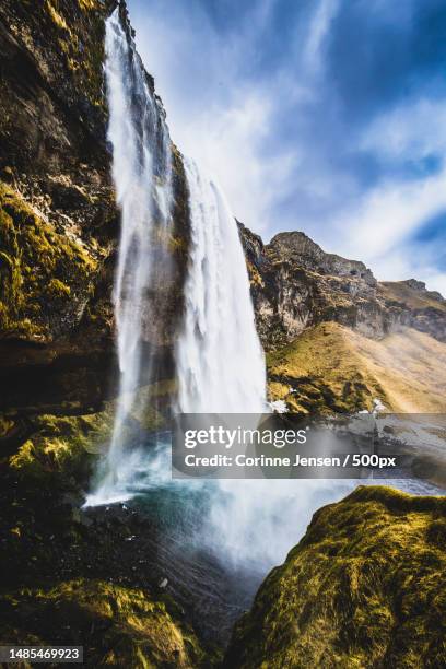 scenic view of waterfall against sky,iceland - corinne paradis stock pictures, royalty-free photos & images