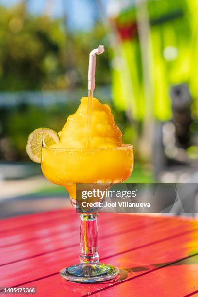 a refreshing mango daiquiri and lime twist. - slushies stock pictures, royalty-free photos & images