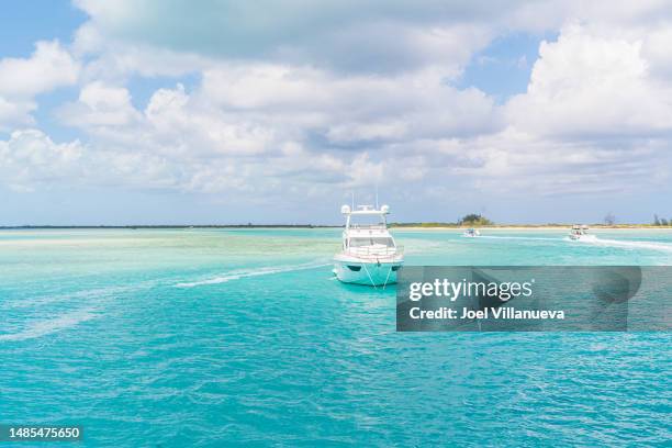 yacht anchored in the stunning turquoise waters of turks and caicos. - turks and caicos islands stock pictures, royalty-free photos & images