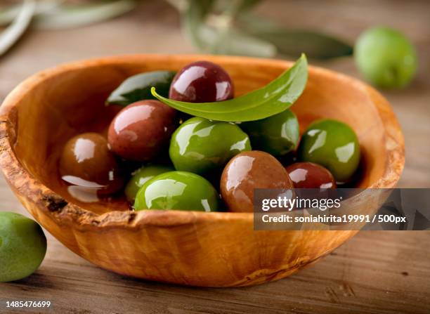 close-up of olives in bowl on table,romania - snack bowl stock pictures, royalty-free photos & images