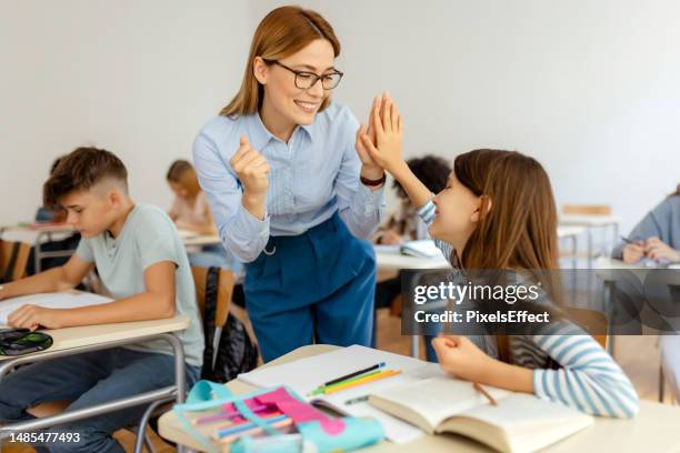 becoming a top student with the help of her teacher - teachers day stock pictures, royalty-free photos & images