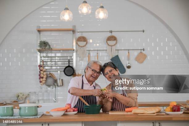 asian senior couples love cooking in a modern kitchen together momnet of love - 2 people back asian stock-fotos und bilder