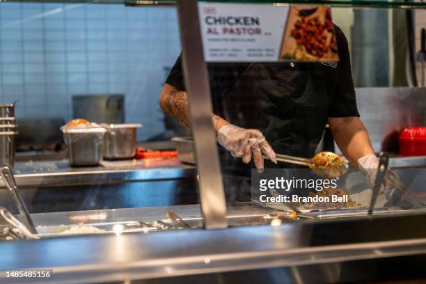 An employee prepares food at a Chipotle Mexican Grill restaurant on April 26, 2023 in Austin, Texas. Chipotle Mexican Grill posted strong quarterly...