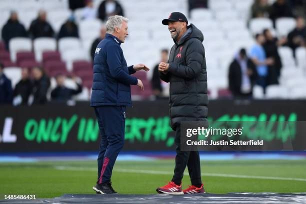 David Moyes, Manager of West Ham United, and Juergen Klopp, Manager of Liverpool, speak during the warm up prior to the Premier League match between...