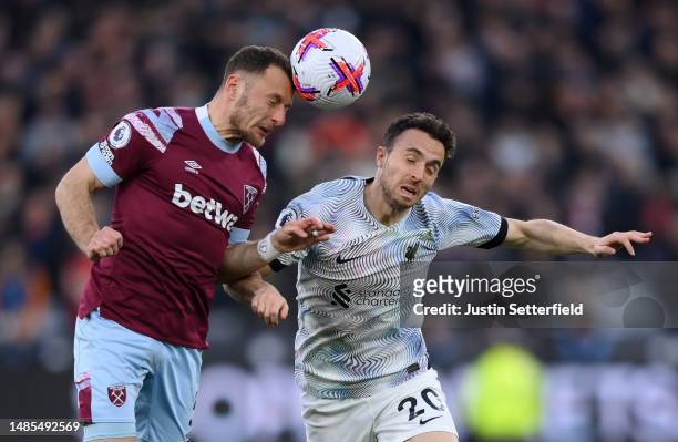 Vladimir Coufal of West Ham United contends for the aerial ball with Diogo Jota of Liverpool during the Premier League match between West Ham United...