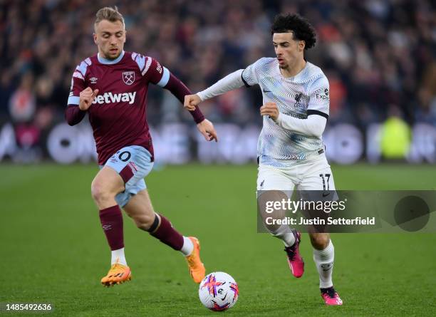 Curtis Jones of Liverpool runs with the ball whilst under pressure from Jarrod Bowen of West Ham United during the Premier League match between West...