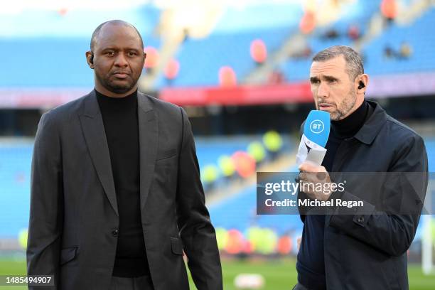 Former Arsenal players Patrick Vieira and Martin Keown look on prior to the Premier League match between Manchester City and Arsenal FC at Etihad...