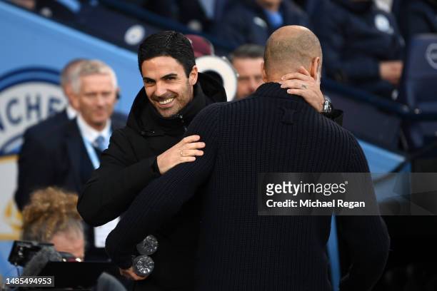 Mikel Arteta, Manager of Arsenal, embraces Pep Guardiola, Manager of Manchester City, prior to the Premier League match between Manchester City and...