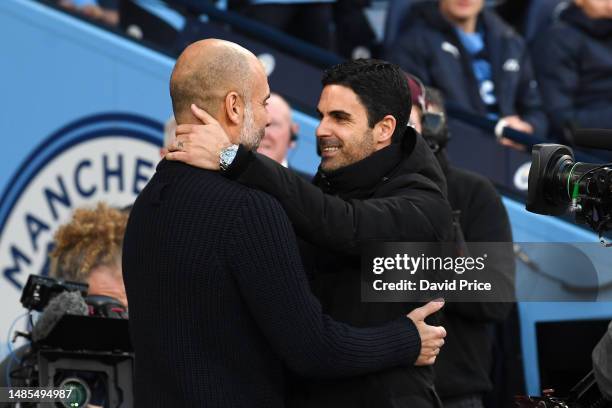 Mikel Arteta, Manager of Arsenal, embraces Pep Guardiola, Manager of Manchester City, prior to the Premier League match between Manchester City and...