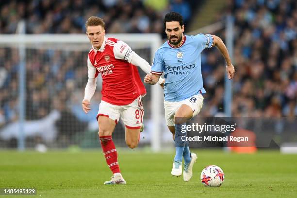 Ilkay Guendogan of Manchester City is challenged by Martin Odegaard of Arsenal during the Premier League match between Manchester City and Arsenal FC...