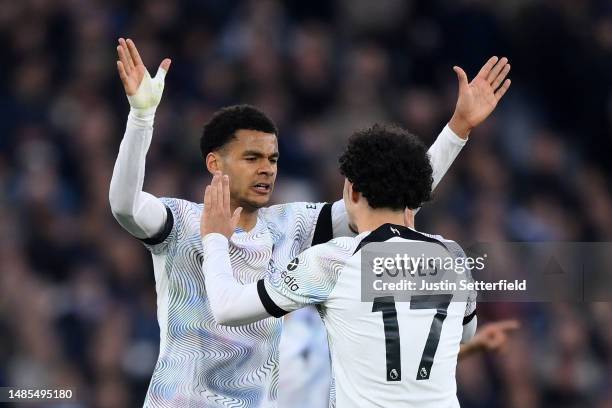 Cody Gakpo of Liverpool celebrates after scoring the team's first goal with teammate Curtis Jones during the Premier League match between West Ham...