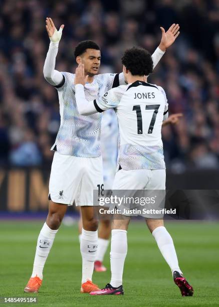 Cody Gakpo of Liverpool celebrates after scoring the team's first goal with teammate Curtis Jones during the Premier League match between West Ham...