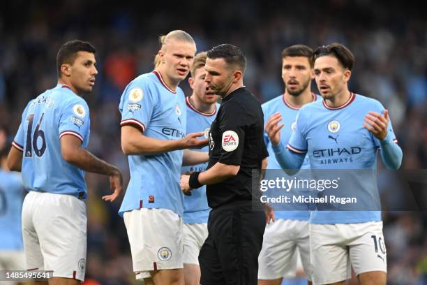 Rodri and Erling Haaland of Manchester City react to Referee Michael Oliver after a penalty appeal during the Premier League match between Manchester...