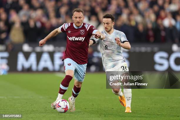 Vladimir Coufal of West Ham United runs with the ball whilst under pressure from Diogo Jota of Liverpool during the Premier League match between West...