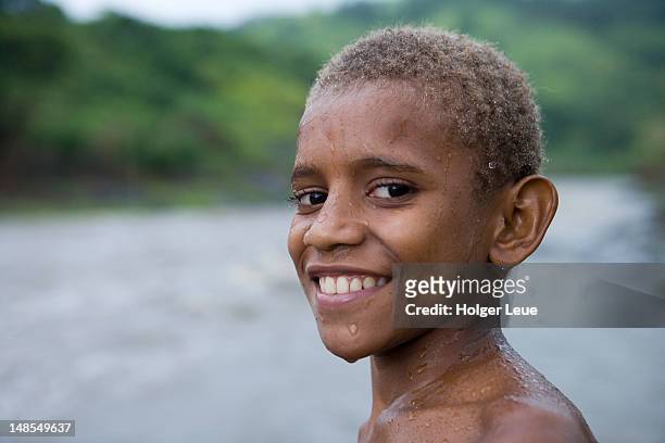 portrait of fijian boy during downpour. - fiji smiling stock pictures, royalty-free photos & images