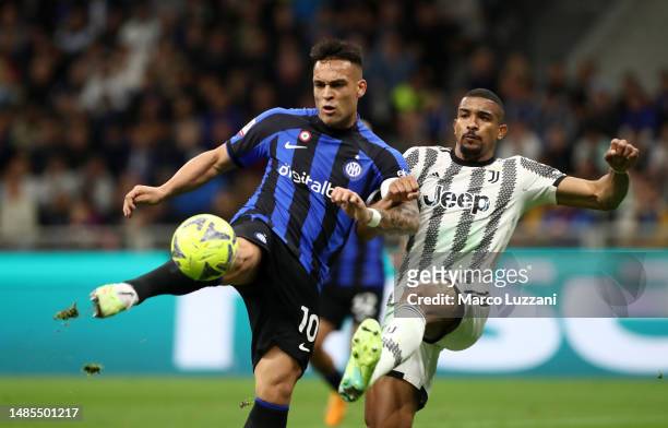 Lautaro Martinez of FC Internazionale clears the ball whilst under pressure from Bremer of Juventus during the Coppa Italia Semi Final between FC...