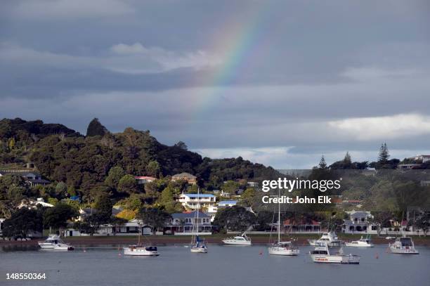 town from offshore, with rainbow. - bay of islands new zealand stock pictures, royalty-free photos & images