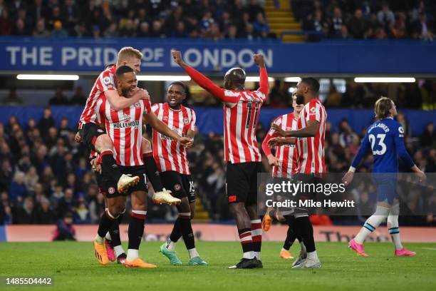 Mathias Zanka Jorgensen of Brentford celebrates with teammates after Cesar Azpilicueta of Chelsea concedes an own goal, the first goal for Brentford,...