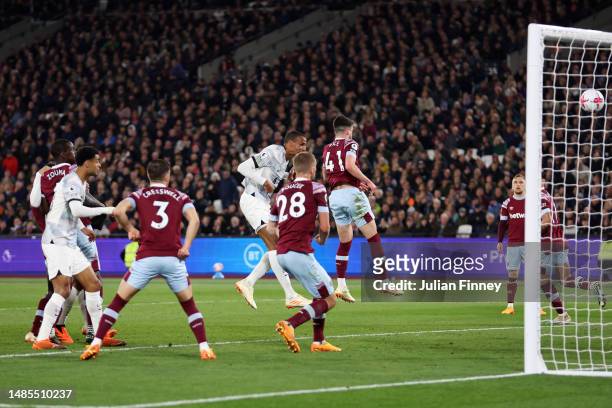 Joel Matip of Liverpool scores the team's second goal whilst under pressure from Declan Rice of West Ham United during the Premier League match...