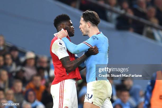 Thomas Partey of Arsenal clashes with Jack Grealish of Manchester City during the Premier League match between Manchester City and Arsenal FC at...