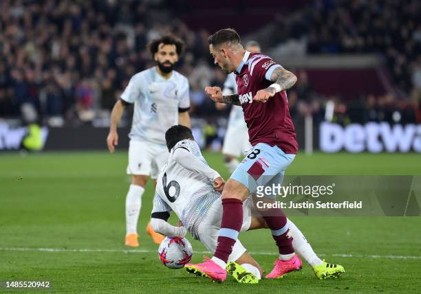 Thiago Alcantara of Liverpool makes contact with the ball whilst challenging Danny Ings of West Ham United, which results in players of West Ham...