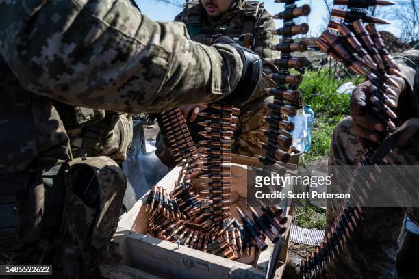 Ukrainian soldiers from the 28th Brigade put bullets into clips for use with light machine guns, as Ukrainian Armed Forces units train for a critical...