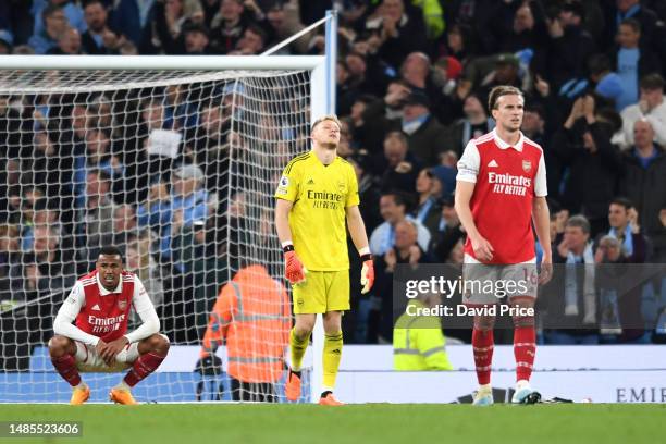 Gabriel and Aaron Ramsdale of Arsenal look dejected after Erling Haaland of Manchester City scored the team's fourth goal during the Premier League...