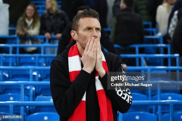 An Arsenal fan reacts after the team's defeat during the Premier League match between Manchester City and Arsenal FC at Etihad Stadium on April 26,...