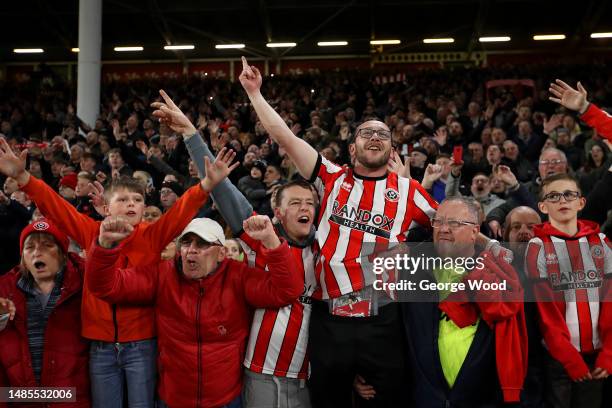 Sheffield United fans celebrate after winning promotion to the Premier League after the team's victory during the Sky Bet Championship between...