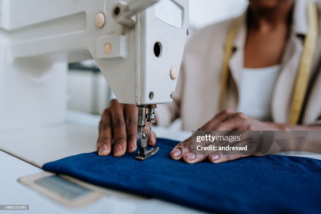 Unrecognizable person sewing using sewing machine