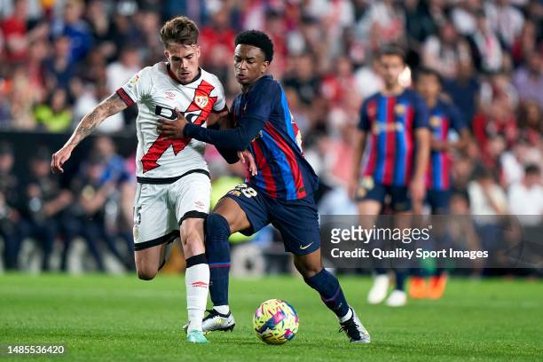 Josep Maria Chavarria of Rayo Vallecano competes for the ball with Alejandro Balde of FC Barcelona during the LaLiga Santander match between Rayo...