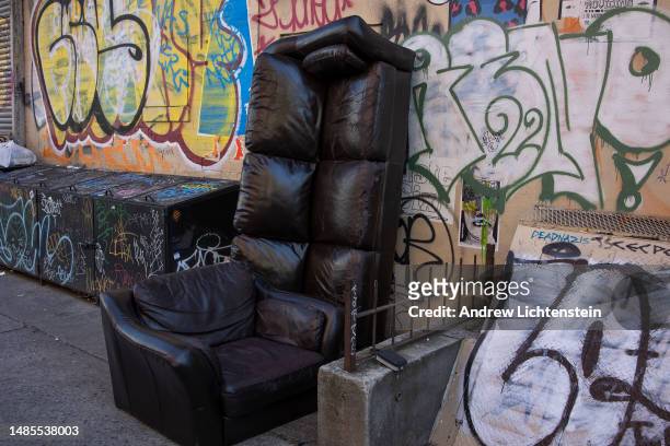Used couch sits on the sidewalk, discarded for trash collection, on March 21, 2023 in the Lower East Side neighborhood of New York City, New York.