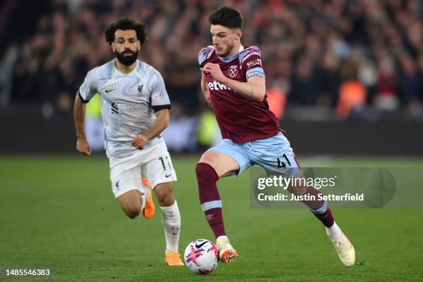 Declan Rice of West Ham United takes on Mohamed Salah of Liverpool during the Premier League match between West Ham United and Liverpool FC at London...