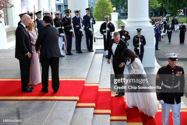 South Korean first lady Kim Keon-hee is assisted by Rufus Gifford, chief of protocol, as U.S. President Joe Biden, first lady Jill Biden greet South...